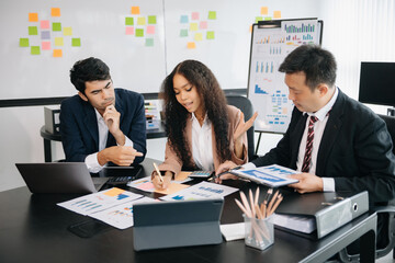 Office colleagues have a casual discussion. During a meeting in a conference room, a group of business teem sit in the conference room new startup project