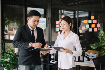 Portrait of success business people working together in home office. Couple teamwork startup concept.