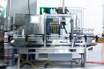 Alcohol beverage production on the factory. aluminium cans on conveyor belt of drink filling machine.