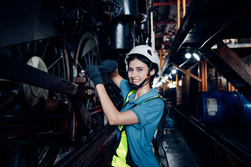Obraz na płótnie Canvas Portrait of female engineer working and looking camera in industrial factory. Women in industry concept.