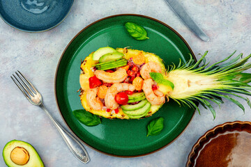 Pineapple stuffed with shrimp, rice and avocado.