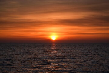 Beautiful colorful background with sunrise over the sea. Morning on the beach in Gdynia, Poland.