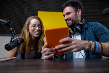 Young man and woman looking involved while searching something online