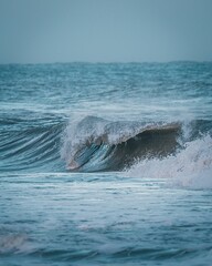 Vertical shot of blue sea waves