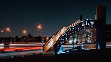 Illuminated stair at night next to traffic lights in the city
