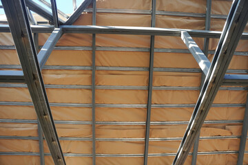 One-sided aluminum foil sheet insulation installed under the roof during construction for...