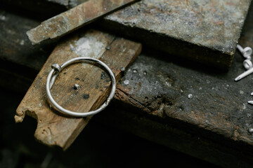 Jeweler at work in jewelry. Desktop for craft jewelry making with professional tools. Close up view of tools. Silver jewelry. Unique local artwork in Nan Province northern thailand	