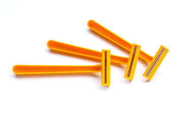 Orange shaving razor isolated on white background