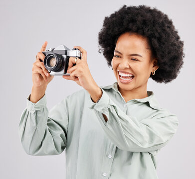 Laughing, camera photographer and black woman in studio isolated on a white background. Photography, professional and funny person or female ready to start filming, photoshoot or taking picture.