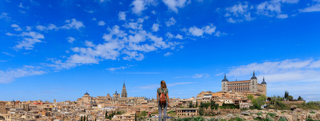 woman tourist standing looking at panorama view of Toledo city landscape in Spain - obrazy, fototapety, plakaty