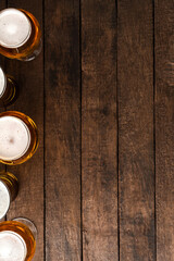Beer glasses on wooden table with copyspace.