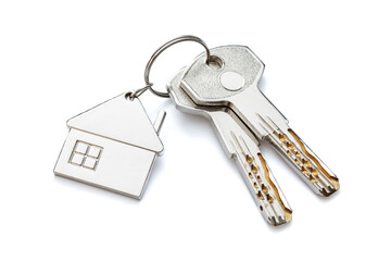 Keychain in the form of a house with two keys. Close-up. Highlighted on a white background.