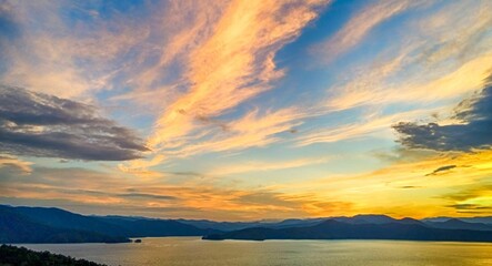 Wide angle of Lake Jocassee surrounded by hills and forests at sunrise in South Carolina, USA