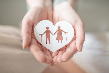 Hands holding heart with elderly couple, concept of wellbeing and mental health in old age, care of...