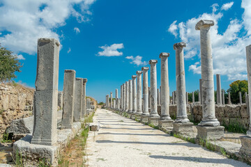Agora of the ancient city of Perge in clear sunny weather. Against the background of a blue sky...