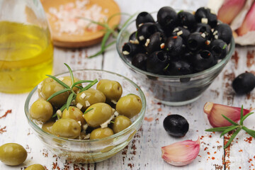 Black and green olives in glass bowls