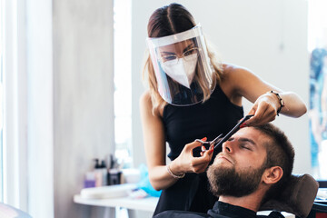 Hairdresser trimming the hair of a client on a salon