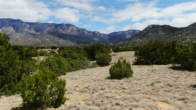 Hiking trial aerial Drone summer reveal forward Sandia Mountains Albuquerque New Mexico