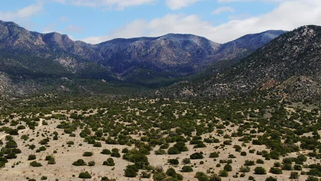 Aerial drone forward reveal Sandia Mountains Albuquerque New Mexico summer hiking trails