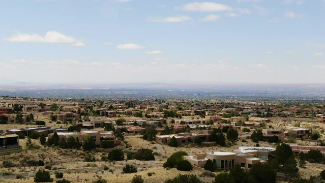Adobe Homes dolly down aerial drone Sandia Mountains Albuquerque New Mexico