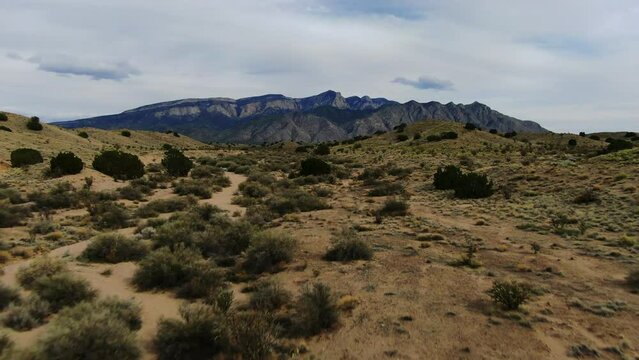 Mountain Trail hike drone aerial forward towards the Sandia Mountains Albuquerque New Mexico