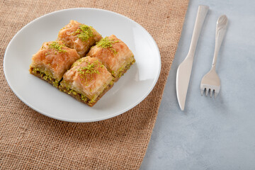 Pistachio Turkish baklava on a white plate,top view
