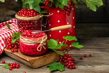 red currant jam in jar. Canned fresh berries on a wooden background. banner, menu, recipe place for text
