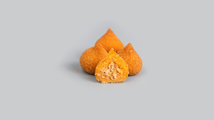 Traditional fried coxinha de frango - croquette of chicken on the grey background, Brazilian snack.