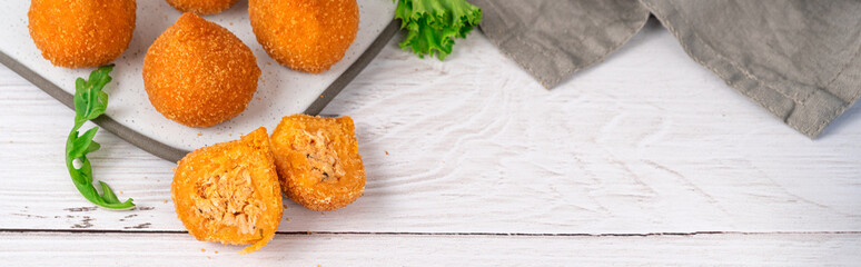 Traditional fried coxinha de frango - croquette of chicken on the white table with copy space
