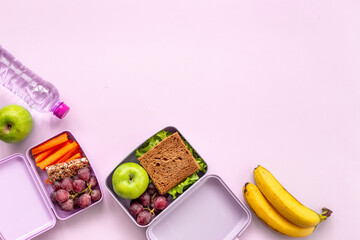 Student meal in purple lunch boxes, top view. Healthy shacks