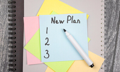 NEW PLAN text concept on color sheets. Planning, new goals.
