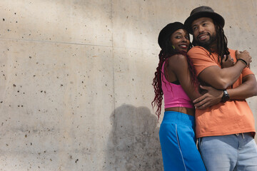 Portrait of African-American couple embracing each other.