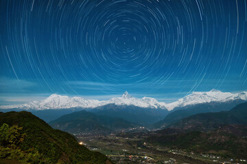 Star trails over Mount Machapuchare and the Annapurna Massif. Himalays. Nepal