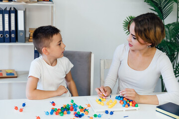 educational games for children a child psychologist is engaged with a boy in the office