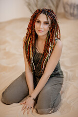 portrait of a woman on the sand with de dreadlocks
