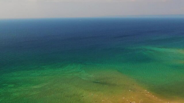 Lake Michigan drone backward movement Up North beautiful aqua water summer day windy