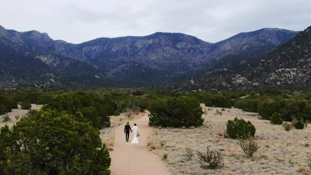 Wedding couple walking holding hands romantic fog wedding couple aerial slow follow  Sandia Mountains Albuquerque New Mexico 2