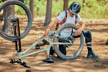 Maintenance, fitness and a man with a bicycle for cycling, fixing a wheel or tire in nature....