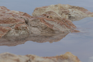 Stones in Pink Lake in Nature Park of the Lagoons of La Mata and Torrevieja, Alicante, Spain