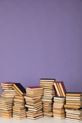 stacks of books scientific literature of knowledge in the library on a purple background