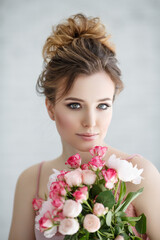portrait of a beauty woman with a bouquet of flowers