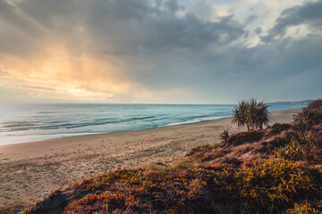 Beautiful dreamy panorama of crushing waves of the Pacific ocean visible from the dunes of the Peregian Beach, Sunshine Coast, Queensland, Australia.