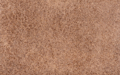 Fototapeta premium Light brown leather surface. Visible structure of the material.