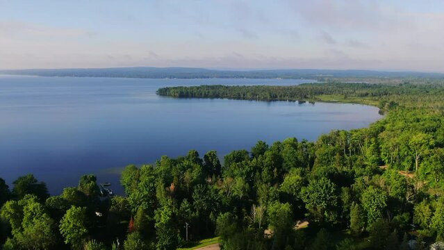 Cottages shoreline boats early morning fog Burt Lake Up North Great Lakes Petosky Harbor Springs Mackinaw up movement Michigan