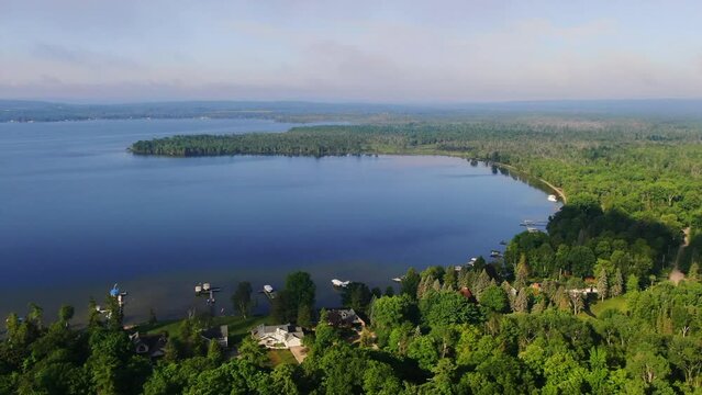 Shoreline early morning fog Burt Lake Up North Great Lakes Petosky Harbor Springs Mackinaw cottage farmland pan right zoom out movement Michigan
