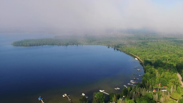 Shoreline early morning fog Burt Lake Up North Great Lakes Petosky Harbor Springs Mackinaw cottage farmland pan right movement Michigan