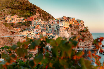 stunning photo captures the breathtaking sunset view of the fishing village of Manarola, located on the Italian coast.