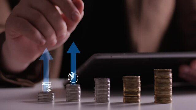 Finance and business concept. Investment graph and rows growth of coins on table. Concept of investing and financial management. 4K