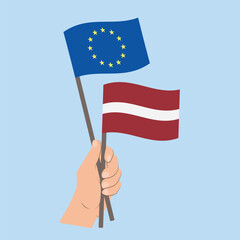 Flags of EU and Latvia, Hand Holding flags