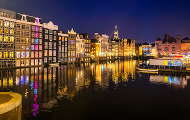 Damrak narrow houses at night in Amsterdam center, Netherlands